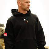 Phalanx Jiu Jitsu premium black oversized hoodie with ranked print, fully enclosed front pocket & patchwork. Made from uniquely sourced premium French terry fabric. High-level Brazilian Jiu-jitsu athletic apparel, the best brand in No Gi.
