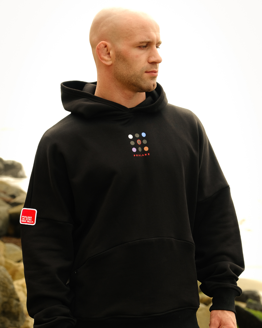 Phalanx Jiu Jitsu premium black oversized hoodie with ranked print, fully enclosed front pocket & patchwork. Made from uniquely sourced premium French terry fabric. High-level Brazilian Jiu-jitsu athletic apparel, the best brand in No Gi.